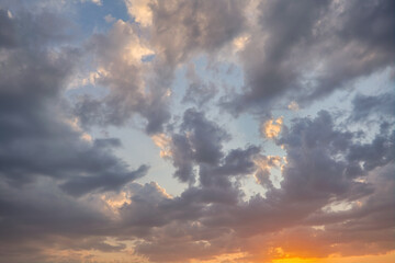 Summer evening sky in the picturesque clouds, lit by the rays of the setting sun.
