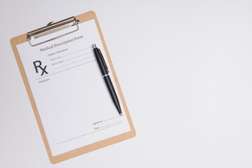Empty medical prescription with a pen isolated. Ballpoint pen lying on medical prescription near phonendoscope in doctors office. © sutlafk