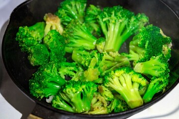 broccoli in a frying pan. Broccoli roasting