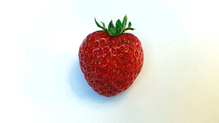 Ripe strawberry fruit on a light background. Ripe strawberry