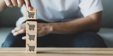 Close up image of business man hand flipping sale volume increase make business grow with icon graph and shopping cart symbol.