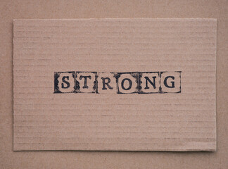 Cardboard with word Strong