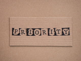 Cardboard with word Priority