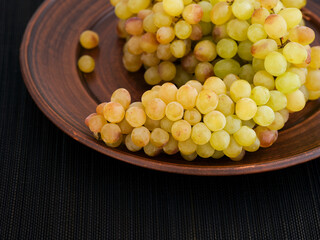 Bunch of rose grapes on a plate.