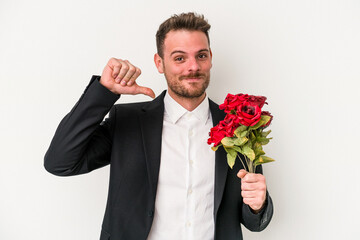 Young caucasian man holding bouquet of flowers isolated on white background feels proud and self confident, example to follow.