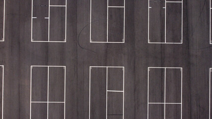 Top view of a small group of asphalted parking lots with white dividing lines 
