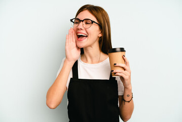 Restaurant waiter woman holding a take away coffee isolated on blue background shouting and holding palm near opened mouth.