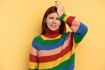 Young English woman isolated on yellow background forgetting something, slapping forehead with palm and closing eyes.