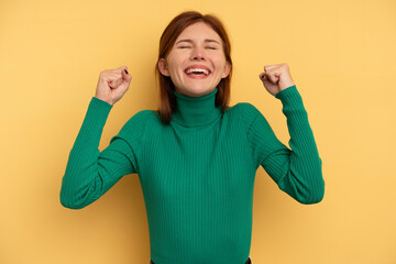 Young English woman isolated on yellow background celebrating a victory, passion and enthusiasm, happy expression.