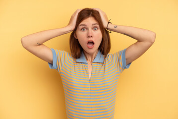 Young English woman isolated on yellow background surprised and shocked.