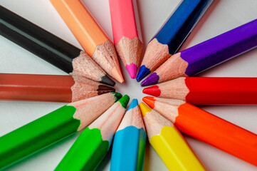 Fototapeta premium Macro - colored pencils in a circle on a white background