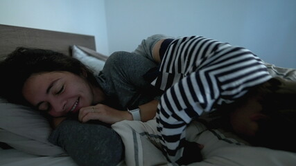 Mother lying in bed in the morning