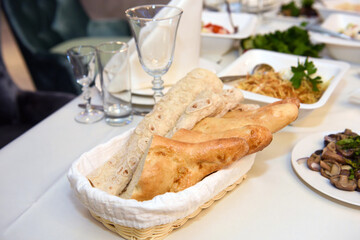 Bread on the festive table. A table with food served with dishes for guests.