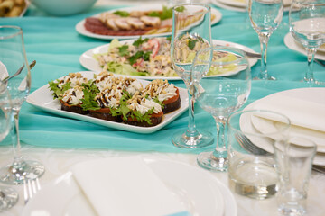 Cold snacks on the festive table. A table with food served with dishes for guests.