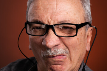 Close-up portrait of an elderly man with skeptical expression