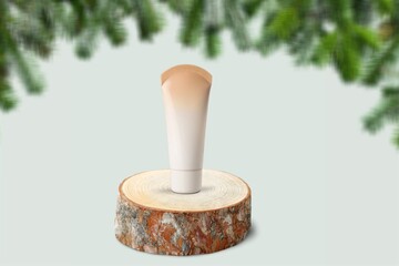 Facial Skincare product tube decorates with Christmas bauble. Cosmetics for festive decoration concept