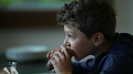 Child eating morning breakfast. Kid eats bread