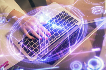 Double exposure of woman hands typing on computer and general theme hologram drawing. Education concept.