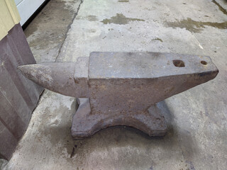 old and rusty anvil in the garage.