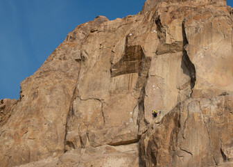 Rock climbers training on Ili river rocky banks