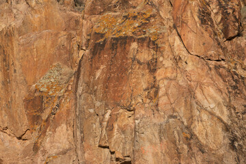 Runes on a rock wall/ Ili river rocky banks.
