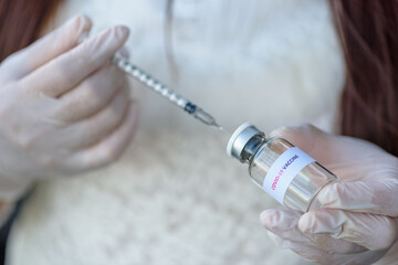 Doctors or nurses provide patients with syringes for the modern Covid-19 vaccine during the global...