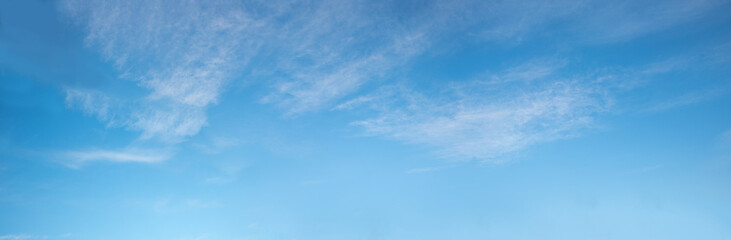 wide blue sky with fluffy cirrus clouds
