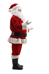 Full length profile shot of Santa Claus geaturing with hands and talking