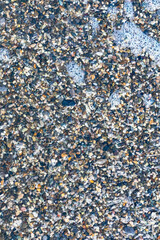 sea beach of small multi-colored pebbles as a natural background