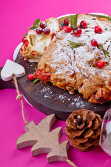 Delicious cranberry pie with fresh cranberries and herbs for Christmas on on a crimson background