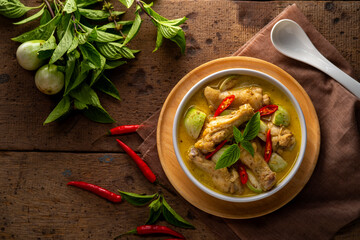 Thai Green Curry With chicken drumsticks in white bowl.asian food.Top view