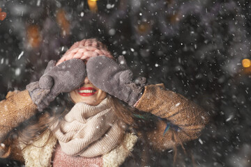 Positive lady in gloves covering her eyes