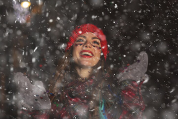 Excited lady enjoying snowy weather at the holiday fair