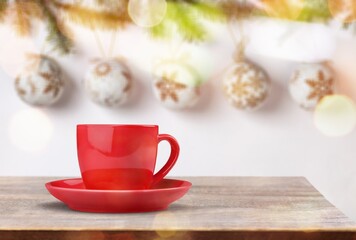 Mug with hot tea standing on a desk in a cozy room