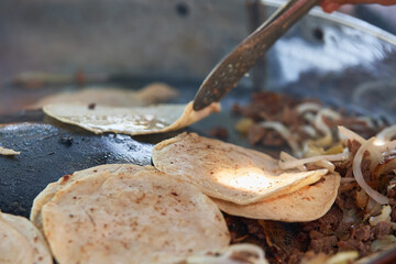 Beef tacos with onion, cilantro and salsa. Street tacos. Mexican tacos. Street sale of tacos.