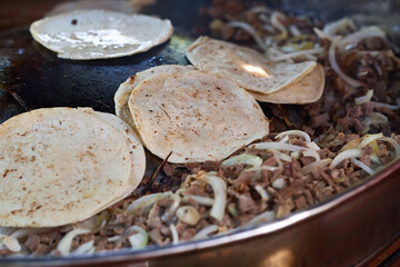 Beef tacos with onion, cilantro and salsa. Street tacos. Mexican tacos. Street sale of tacos.