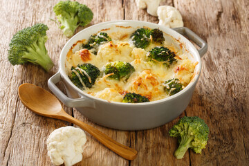 Homemade delicious creamy broccoli cauliflower vegetable casserole close up in a pot on an old...