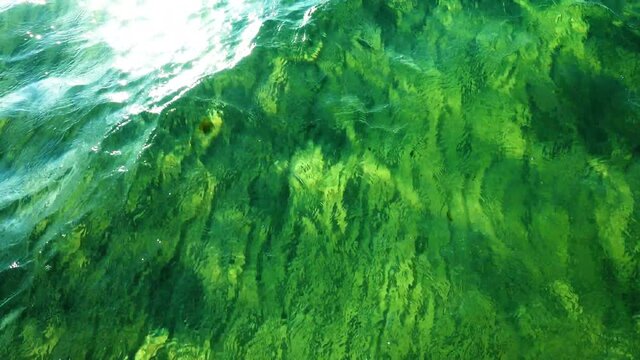 Sea sandy bottom with sun glare. This is what the sea looks like when you go into the water for swimming