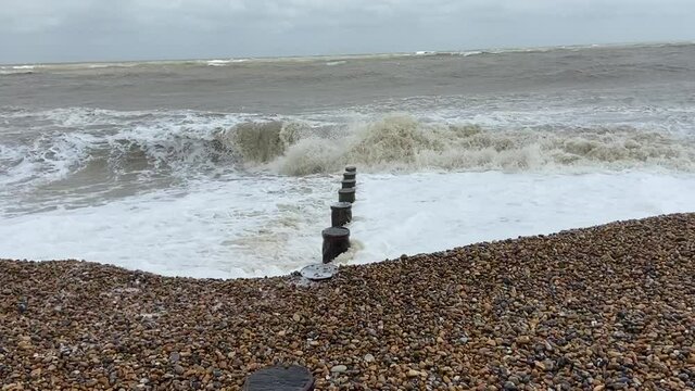 Winchelsea Beach at Pett level, East Sussex, UK - popular summer beach destination for tourists, walkers, hikers, and dog walkers, rugged coast on south of England - stock footage