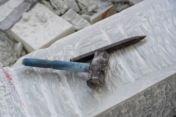 Sculptor tools on a marble slab, close up. Workplace, traditional tools sculptor, red chalk, ruler,...
