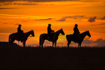 Three cowboy silhouettes