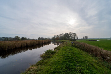 Obraz premium Autumn landscape photo of the Winkel river, The Netherlands