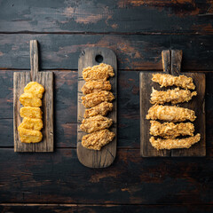 Crispy fried chicken on old dark wooden table, top view