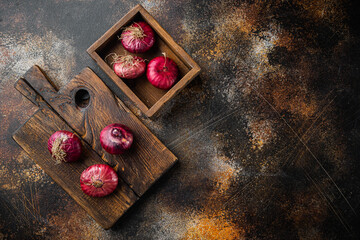 Purple Onions, on old dark rustic background, top view flat lay  with copy space for text