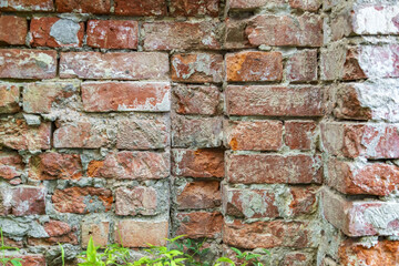 Embossed textured surface of an old wall made of facade bricks and cement