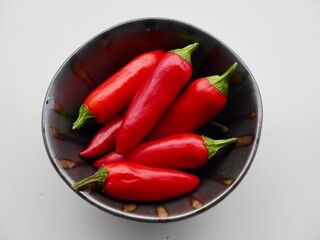 Aerial view of red hot chilis on Nordic ceramic plate.