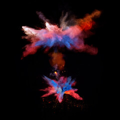 Bizarre forms of red and blue powder paint explode in front of a black background to give off fantastic multi colors and forms.