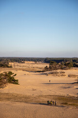 People walking on a sanddune