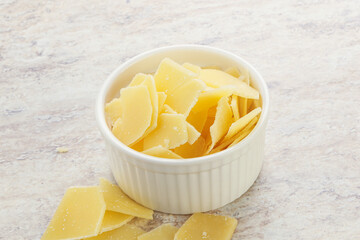 Sliced parmesan cheese heap in the bowl