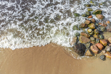 Top view of water rocks and sand.
